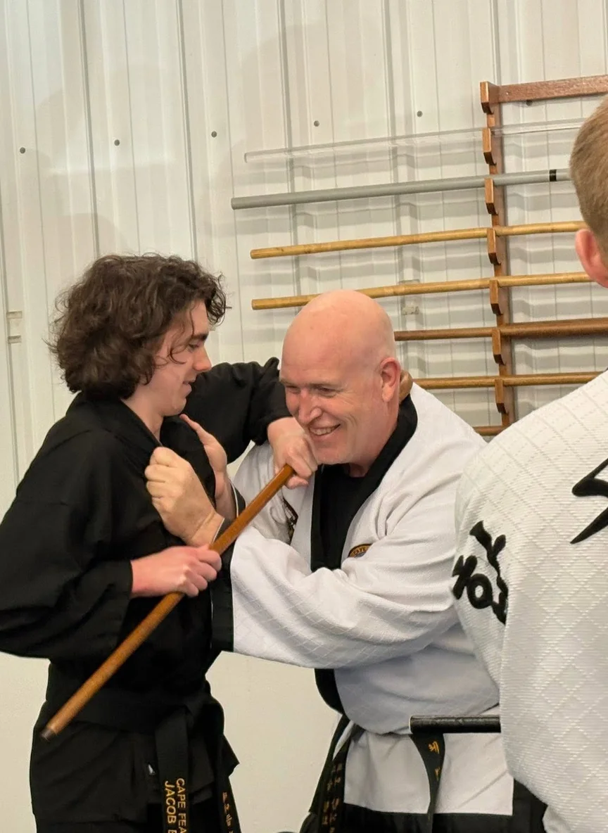 Kevin Deane, Owner & Head Instructor at Cape Fear Martial Arts, coaching a student